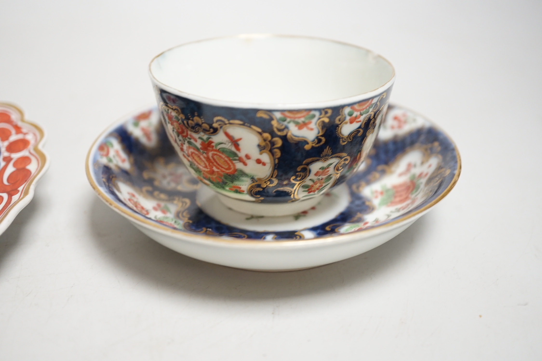 A Worcester kakiemon style scale blue trio, c.1770, a Worcester Queen Charlotte’s pattern plate, 19.5 cm and a Samson saucer in Worcester style